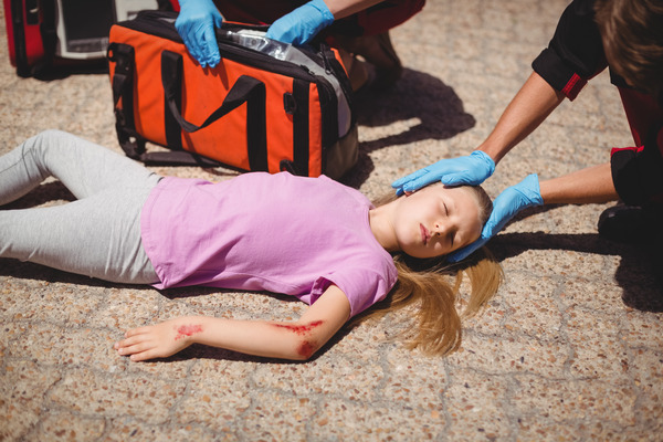 CMS & Ed health worker giving first aid to a child girl